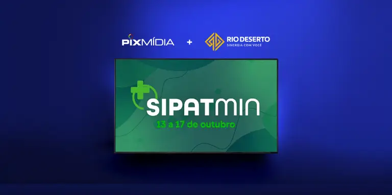 Tela exibe comunicado interno da empresa Rio Deserto por meio de um software de TV corporativa